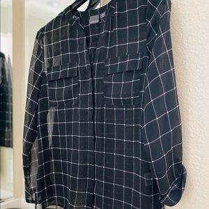 A light button up shirt that is lose fit